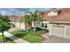 Attractive home with well-kept landscaping, swaying palms, and convenient two-car garage at 1064 Quaker Ridge Ln, Davenport, FL 33896