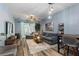 Spacious living room with a comfortable gray sofa, stylish decor, and natural light at 1064 Quaker Ridge Ln, Davenport, FL 33896