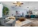 Open living space with a gray sofa, stylish furnishings, and access to the kitchen at 1064 Quaker Ridge Ln, Davenport, FL 33896
