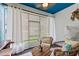 Inviting patio with comfortable seating, stylish decor, and blue-painted ceiling at 1064 Quaker Ridge Ln, Davenport, FL 33896