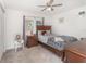 Cozy bedroom featuring plush carpet, natural light, and ceiling fan at 108 Honeywood Ct, Kissimmee, FL 34743