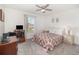 Bedroom with large window, ceiling fan, a workspace desk and neutral carpeting at 108 Honeywood Ct, Kissimmee, FL 34743