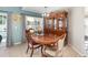 Dining room with pool view, table, hutch, and stylish decor with neutral paint at 108 Honeywood Ct, Kissimmee, FL 34743
