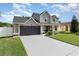 Charming two-story home with a manicured lawn, gray siding, and a spacious two-car garage at 108 Honeywood Ct, Kissimmee, FL 34743