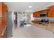 Galley kitchen with stainless steel appliances, granite countertops, and tiled floors at 108 Honeywood Ct, Kissimmee, FL 34743