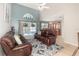 Bright living room with high ceilings, leather couches, and sliding doors leading to the pool area at 108 Honeywood Ct, Kissimmee, FL 34743