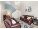 Inviting living space with a staircase, comfortable sofas, and a ceiling fan at 108 Honeywood Ct, Kissimmee, FL 34743