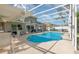 Inviting screened-in pool area with ample seating, perfect for outdoor relaxation at 108 Honeywood Ct, Kissimmee, FL 34743