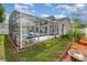 Screened-in pool area with outdoor seating, grassy area, and fire pit at 108 Honeywood Ct, Kissimmee, FL 34743