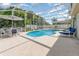 Sparkling screened pool with deck area and outdoor furniture for relaxation at 108 Honeywood Ct, Kissimmee, FL 34743