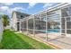 Large screened in pool with seating areas, a spacious deck, and green landscape at 108 Honeywood Ct, Kissimmee, FL 34743