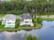 Scenic aerial shot of homes surrounding a beautiful pond, blending community living with nature's tranquility at 10950 Belle Maisons Dr, Orlando, FL 32832