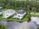 Aerial view captures a neighborhood with a beautiful pond, showcasing picturesque homes and landscaping at 10950 Belle Maisons Dr, Orlando, FL 32832