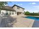 The backyard features a stunning pool and large patio at 10950 Belle Maisons Dr, Orlando, FL 32832