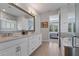 Bright bathroom featuring double vanity, soaking tub and glass enclosed shower at 10950 Belle Maisons Dr, Orlando, FL 32832