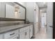 Bathroom featuring a granite vanity, framed mirror, and decorative fixtures at 10950 Belle Maisons Dr, Orlando, FL 32832