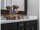 Nicely decorated bathroom countertop with decor elements and black cabinets at 10950 Belle Maisons Dr, Orlando, FL 32832