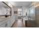 Bright bathroom featuring double vanity, soaking tub and glass enclosed shower at 10950 Belle Maisons Dr, Orlando, FL 32832