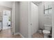 Bright bathroom with a toilet and shower, connected to an elegant bedroom at 10950 Belle Maisons Dr, Orlando, FL 32832