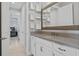 Bathroom featuring a granite vanity, framed mirror, and built-in shelving at 10950 Belle Maisons Dr, Orlando, FL 32832