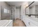 Modern bathroom featuring a walk-in shower, double vanity, and neutral tile flooring at 10950 Belle Maisons Dr, Orlando, FL 32832