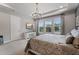 Bright bedroom with a chandelier, a TV, and large windows offering plenty of natural light at 10950 Belle Maisons Dr, Orlando, FL 32832
