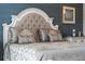 Comfortable bedroom showcasing a tufted headboard, decorative pillows, and luxurious bedding at 10950 Belle Maisons Dr, Orlando, FL 32832