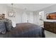 Bedroom featuring a bed, dresser, and bathroom with double vanity at 10950 Belle Maisons Dr, Orlando, FL 32832