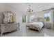 Elegant bedroom featuring tile floors, brick wall, and decorative furniture at 10950 Belle Maisons Dr, Orlando, FL 32832