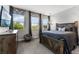 Bedroom with a large bed, dresser, and large windows with natural light at 10950 Belle Maisons Dr, Orlando, FL 32832