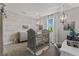 Elegant Bedroom featuring a decorative crib, mural, and chandelier at 10950 Belle Maisons Dr, Orlando, FL 32832