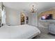 Elegant bedroom featuring a chandelier, and a decorative accent wall with mounted television at 10950 Belle Maisons Dr, Orlando, FL 32832