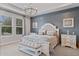 Bright bedroom featuring a cozy bench, elegant decor, and a relaxing ambiance at 10950 Belle Maisons Dr, Orlando, FL 32832