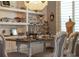 Charming dining room featuring elegant decor, designer chandelier, and ample display shelving at 10950 Belle Maisons Dr, Orlando, FL 32832