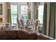 Inviting dining space filled with natural light, adjacent to the kitchen and living area at 10950 Belle Maisons Dr, Orlando, FL 32832