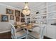 Dining room with decorative chandelier and artwork on the walls at 10950 Belle Maisons Dr, Orlando, FL 32832