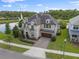 Stunning two-story home featuring stone accents, a paver driveway, and a well-manicured lawn in a desirable neighborhood at 10950 Belle Maisons Dr, Orlando, FL 32832