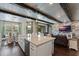 Open floor plan featuring a spacious kitchen with island and adjacent living area with stone accent wall at 10950 Belle Maisons Dr, Orlando, FL 32832