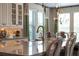 Bright kitchen area featuring granite countertops and stainless steel appliances, with ample natural light at 10950 Belle Maisons Dr, Orlando, FL 32832