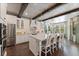 Bright kitchen with large island, seating, stainless steel appliances and hard wood floors at 10950 Belle Maisons Dr, Orlando, FL 32832