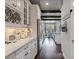 Long shot of kitchen featuring white cabinets, stainless steel appliances, and hardwood floors at 10950 Belle Maisons Dr, Orlando, FL 32832
