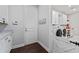 Bright laundry room featuring modern appliances and ample storage at 10950 Belle Maisons Dr, Orlando, FL 32832