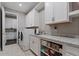 Bright laundry room featuring modern appliances, a sink, and ample storage at 10950 Belle Maisons Dr, Orlando, FL 32832