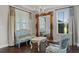 Formal living room featuring elegant seating, a large ornate mirror, and natural light from the window at 10950 Belle Maisons Dr, Orlando, FL 32832