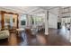 Elegant formal living and dining room with wood floors, large mirror and seating at 10950 Belle Maisons Dr, Orlando, FL 32832