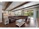 Open concept living room with beamed ceilings, kitchen, and hardwood floors at 10950 Belle Maisons Dr, Orlando, FL 32832