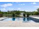 Inviting pool overlooks a tranquil lake and fountain at 10950 Belle Maisons Dr, Orlando, FL 32832