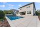 Inviting pool and patio area view of the home's rear exterior at 10950 Belle Maisons Dr, Orlando, FL 32832