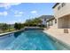 Sparkling pool and patio overlook the lake at 10950 Belle Maisons Dr, Orlando, FL 32832