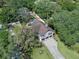 Overhead view of home with two-car garage, manicured lawn, and sparkling swimming pool at 11951 Elbert St, Clermont, FL 34711